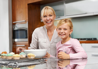 Mother, portrait or child baking in kitchen or happy family with an excited girl learning cupcake recipe. Home, daughter or proud mom with muffin or smile for helping or teaching kid for development