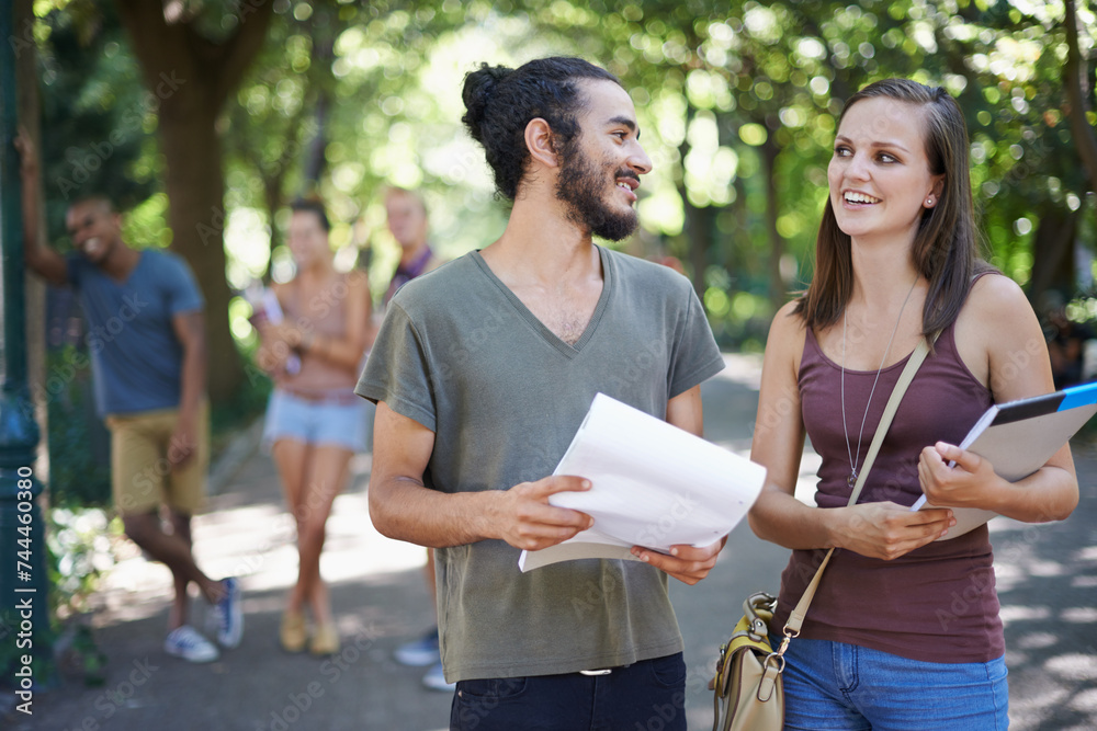 Wall mural Students, friends and learning or talking on campus with education, knowledge and notebook or notes at college. Happy people with outdoor conversation, park and university for studying collaboration