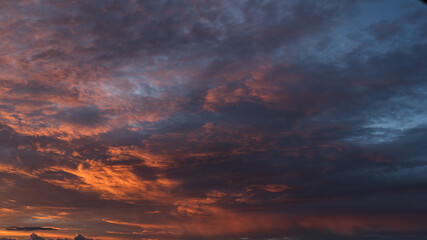 Dramatic sunset with vibrant clouds lit by a sun