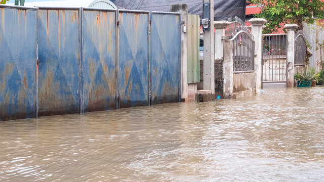 Unusually high sea levels caused water to flood roads in residential communities next to the river