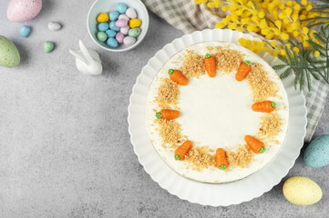 Homemade Easter carrot cake made with walnuts, iced with cream cheese. Sweet dessert.