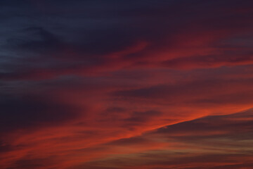 Dramatic sunset with vibrant clouds lit by a sun