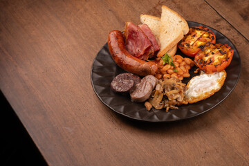 english breakfast irish uk with plenty of protein sweet beans sausage bacon egg mushrooms wooden table