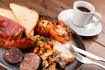 english irish uk breakfast dish with lots of protein sweet beans and cup of coffee close up