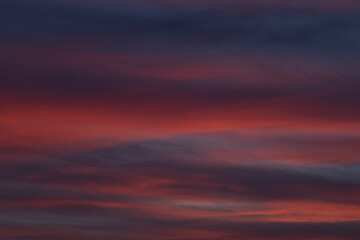Dramatic sunset with vibrant clouds lit by a sun