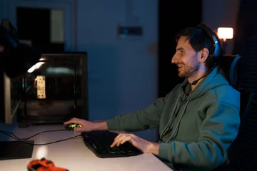 Foto op Plexiglas A happy gamer laughs during a relaxed gaming session, enjoying the leisure time © arthurhidden