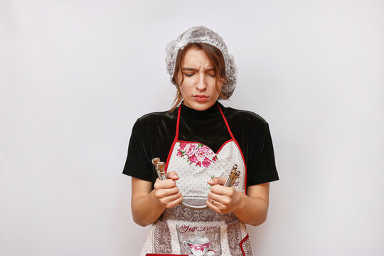 A beautiful girl holds water hoses in her hands. Housework concept.