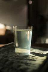 Glass of tonic water on linen napkin indoor