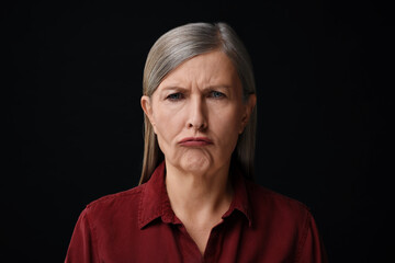 Personality concept. Portrait of emotional woman on black background