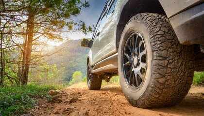 Fototapeta na wymiar Exploring the Outdoors: Detailed Shots of SUV Wheels Conquering Dirt Roads