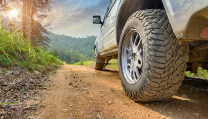 Fototapeta na wymiar Exploring the Outdoors: Detailed Shots of SUV Wheels Conquering Dirt Roads