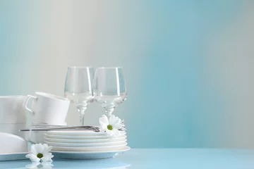 Foto op Plexiglas Set of many clean dishware, cutlery, flowers and glasses on light blue table. Space for text © New Africa