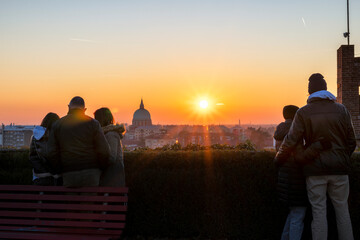 Tourists silhouette looking at an Italian city at sunset. Udine, Friuli Venezia Giulia, Italy.