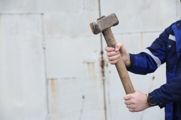 Man with sledgehammer outdoors, closeup. Space for text - obrazy, fototapety, plakaty