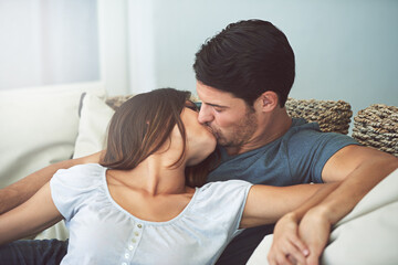 Love, kissing and couple relaxing on sofa by patio cuddling and bonding for marriage at home....