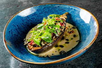 Stuffed Eggplant oven baked with sauce on plate