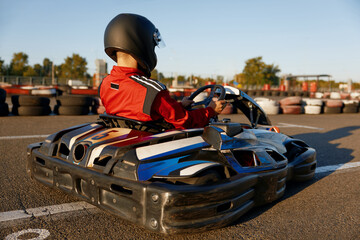 Diver racing on go-cart track outdoors enjoying competitive activity