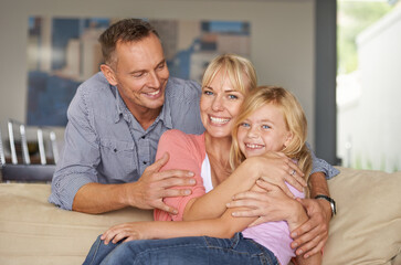Obraz premium Portrait, child or parents on couch with love, relax or bonding together for peace on weekend. Father, mother and daughter for happy family with care, vacation and excited face for hugging in lounge
