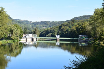 Fototapeta na wymiar mirror calm reservoir of river Our / Sauer with the dam
