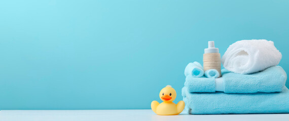 banner. Baby cosmetic products, bath ducks, sponge and towels on light blue background. Space for text. mock-up - obrazy, fototapety, plakaty
