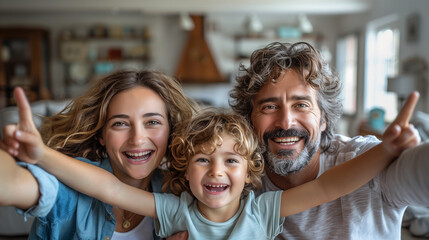 Real estate and mortgage concept : Family with child having fun in new home. Joyful first-time buyers in living room. Real estate, residential mortgage, moving into dream house.