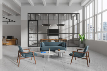 Stylish office interior with relax space, coworking and meeting near window