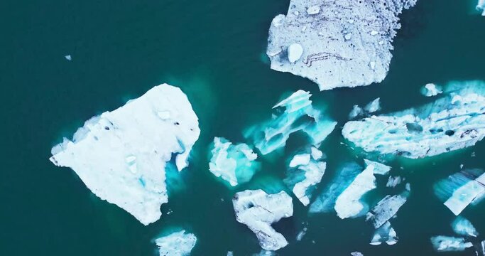 Icebergs from melting glacier in Jokulsarlon lagoon in Iceland, Arctic nature ice landscape in Unesco World Heritage Site, Drone aerial video top view - Climate Change and Global Warming.