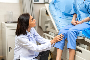 Fototapeta premium Portrait of smiling caring senior doctor trainer carer helping physical discussing and consulting taking care with sick woman patien doing exercises at hospital.care and insurance concept