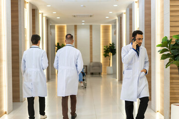 Doctors team in white lab coats of healthcare professional medical at modern hospital corridor,...