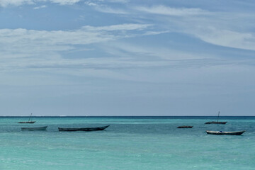 Fototapeta na wymiar Scenic view of moored boats at Jambiani beach, Zanzibar