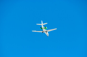 Airplane in the blue sky viewed from below
