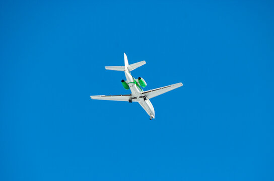 Airplane in the blue sky viewed from below