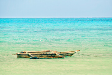 Obraz premium Scenic view of moored boat at Jambiani beach, Zanzibar
