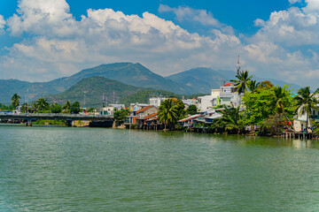 Fototapeta na wymiar Houses on the river bank.The Kai River in Nha Trang in Vietnam. The urban landscape.
