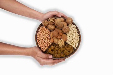 Embracing Health: Hands Holding a Bowl of Assorted Nuts and Dried Fruits, This image features a pair of hands gracefully holding a wooden bowl filled with an assortment of nuts and dried fruits.
