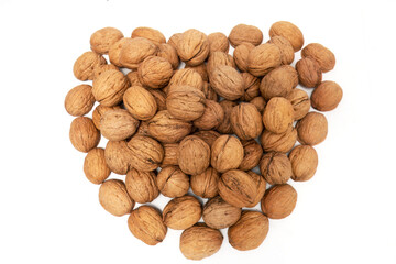 Nature's Gift: Fresh Organic Walnuts in Heart Shape, A striking image capturing a heart shape amidst a scattered pile of fresh, organic walnuts. Against a clean white background, the brown walnuts
