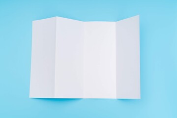 Four Fold White Template Paper Blue Background 4