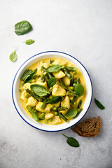 Homemade chicken curry with spinach and pea