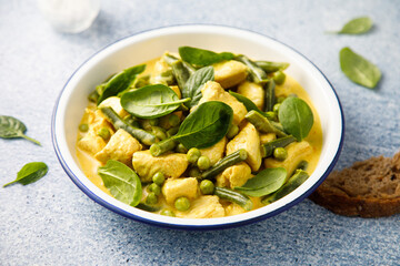 Homemade chicken curry with spinach and pea