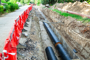 Laying new large diameter water pipes in the ground in the city.