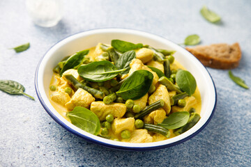 Homemade chicken curry with spinach and pea