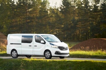 Commercial van on the road. Delivery van close-up mockup isolated. Final destination shipping truck mock-up. Door-to-door business and customers delivery.