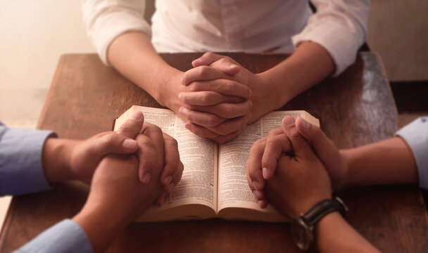 Pray to God with the Bible for forgiveness and believe. Three men pray together, gratitude, trust, and friends in a circle praying together for religion, community, and connection.