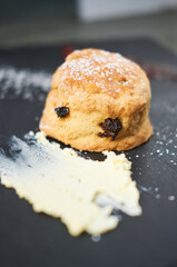 A beautiful gourmet scone served with tea and coffee, strawberry jam and clotted cream. traditional british food. Cackes and see treats