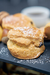 A beautiful gourmet selection of english afternoon tea cakes and scones served with organic...