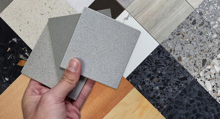 interior architect compares multi color of artificial stones with swatches or palette of material...