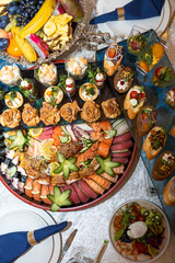 A buffet in a chic hotel with seafood, sushi, salads, fruits and pastries