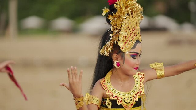 Dramatic preteen balinese dancer with traditional headdress and attire, bali