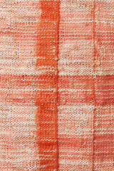 Background of deep peach checkered pattern with a strong fabric texture