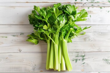 Green fresh celery sticks on wooden background